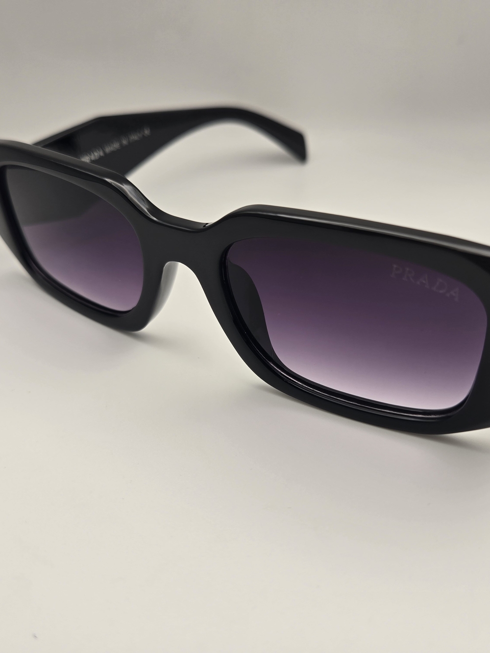 Prada Black Frame Sunglasses with Purple Gradient Lenses